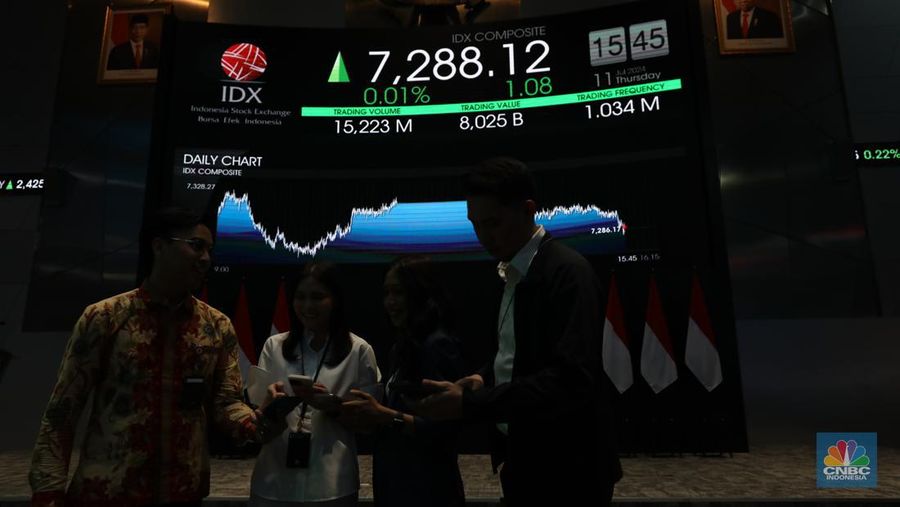 Karyawan berdiri dengan latar belakang layar digital pergerakan Indeks Harga Saham Gabungan (IHSG) di Bursa Efek Indonesia, Jakarta, Kamis (11/7/2024). (CNBC Indonesia/Tri Susilo)