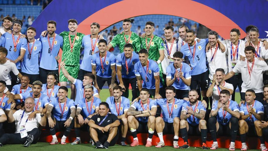 Uruguay players pose with their medals after beating Canada in a penalty shootout during the Copa America third place soccer match in Charlotte, N.C., Saturday, July 13, 2024. (AP Photo/Nell Redmond)