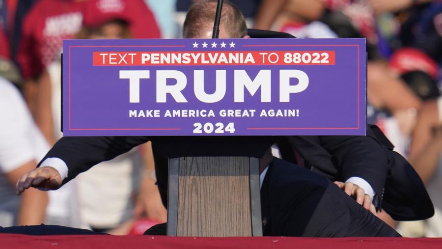 U.S. Secret Service agents surround Republican presidential candidate former President Donald Trump at a campaign event in Butler, Pa., on Saturday, July 13, 2024. (AP Photo/Gene J. Puskar)