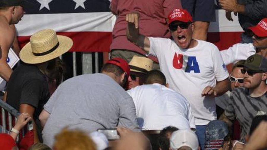 Republican candidate Donald Trump is seen with blood on his face surrounded by secret service agents as he is taken off the stage at a campaign event at Butler Farm Show Inc. in Butler, Pennsylvania, July 13, 2024. Republican candidate Donald Trump was evacuated from the stage at today's rally after what sounded like shots rang out at the event in Pennsylvania, according to AFP.
The former US president was seen with blood on his right ear as he was surrounded by security agents, who hustled him off the stage as he pumped his first to the crowd.
Trump was bundled into an SUV and driven away. (Photo by Rebecca DROKE / AFP)