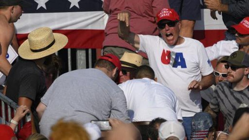 Republican candidate Donald Trump is seen with blood on his face surrounded by secret service agents as he is taken off the stage at a campaign event at Butler Farm Show Inc. in Butler, Pennsylvania, July 13, 2024. Republican candidate Donald Trump was evacuated from the stage at today's rally after what sounded like shots rang out at the event in Pennsylvania, according to AFP.
The former US president was seen with blood on his right ear as he was surrounded by security agents, who hustled him off the stage as he pumped his first to the crowd.
Trump was bundled into an SUV and driven away. (Photo by Rebecca DROKE / AFP)