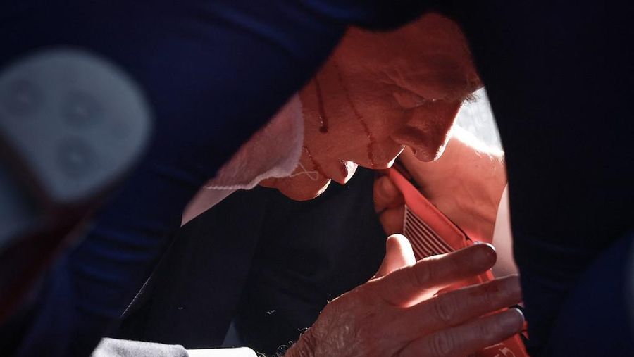 BUTLER, PENNSYLVANIA - JULY 13: Republican presidential candidate former President Donald Trump is shown covered by U.S. Secret Service agents after an incident during a rally on July 13, 2024 in Butler, Pennsylvania. Butler County district attorney Richard Goldinger said the shooter is dead after injuring former U.S. President Donald Trump, killing one audience member and injuring another in the shooting. Anna Moneymaker/Getty Images/AFP (Photo by Anna Moneymaker / GETTY IMAGES NORTH AMERICA / Getty Images via AFP)
