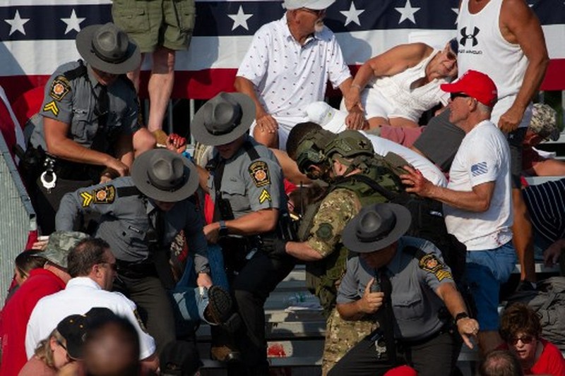 US-POLITICS-VOTE Republican candidate Donald Trump is seen with blood on his face surrounded by secret service agents as he is taken off the stage at a campaign event at Butler Farm Show Inc. in Butler, Pennsylvania, July 13, 2024. Republican candidate Donald Trump was evacuated from the stage at today's rally after what sounded like shots rang out at the event in Pennsylvania, according to AFP.
The former US president was seen with blood on his right ear as he was surrounded by security agents, who hustled him off the stage as he pumped his first to the crowd.
Trump was bundled into an SUV and driven away. (Photo by Rebecca DROKE / AFP)
