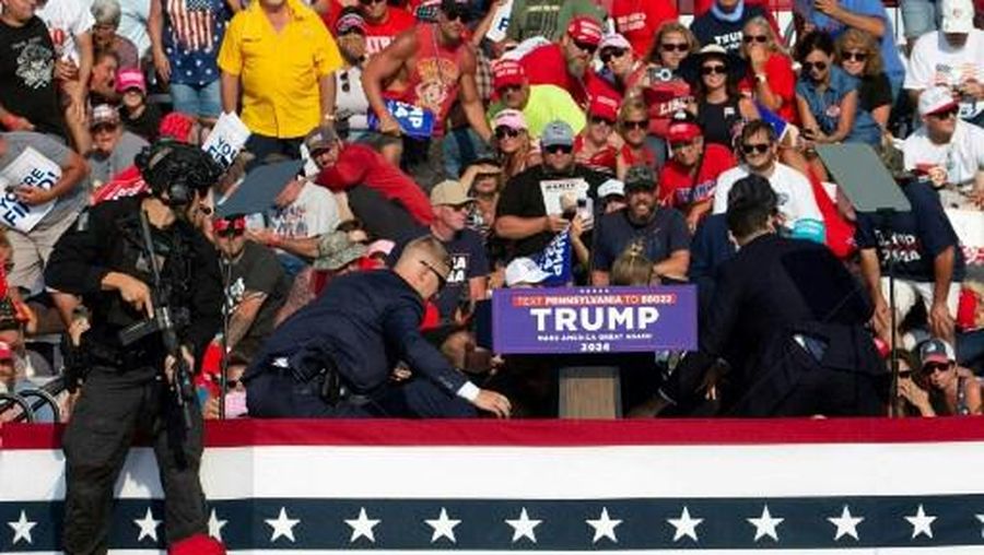 Republican candidate Donald Trump is seen with blood on his face surrounded by secret service agents as he is taken off the stage at a campaign event at Butler Farm Show Inc. in Butler, Pennsylvania, July 13, 2024. Republican candidate Donald Trump was evacuated from the stage at today's rally after what sounded like shots rang out at the event in Pennsylvania, according to AFP.
The former US president was seen with blood on his right ear as he was surrounded by security agents, who hustled him off the stage as he pumped his first to the crowd.
Trump was bundled into an SUV and driven away. (Photo by Rebecca DROKE / AFP)