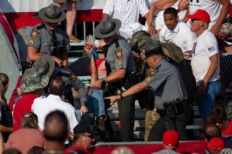 US-POLITICS-VOTE Republican candidate Donald Trump is seen with blood on his face surrounded by secret service agents as he is taken off the stage at a campaign event at Butler Farm Show Inc. in Butler, Pennsylvania, July 13, 2024. Republican candidate Donald Trump was evacuated from the stage at today's rally after what sounded like shots rang out at the event in Pennsylvania, according to AFP.
The former US president was seen with blood on his right ear as he was surrounded by security agents, who hustled him off the stage as he pumped his first to the crowd.
Trump was bundled into an SUV and driven away. (Photo by Rebecca DROKE / AFP)