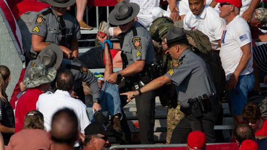 Republican candidate Donald Trump is seen with blood on his face surrounded by secret service agents as he is taken off the stage at a campaign event at Butler Farm Show Inc. in Butler, Pennsylvania, July 13, 2024. Republican candidate Donald Trump was evacuated from the stage at today's rally after what sounded like shots rang out at the event in Pennsylvania, according to AFP.
The former US president was seen with blood on his right ear as he was surrounded by security agents, who hustled him off the stage as he pumped his first to the crowd.
Trump was bundled into an SUV and driven away. (Photo by Rebecca DROKE / AFP)