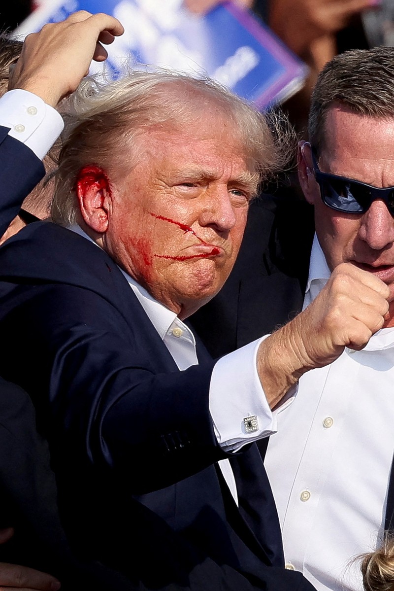 Election 2024 Trump Republican presidential candidate former President Donald Trump is helped off the stage at a campaign event in Butler, Pa., on Saturday, July 13, 2024. (AP Photo/Gene J. Puskar)