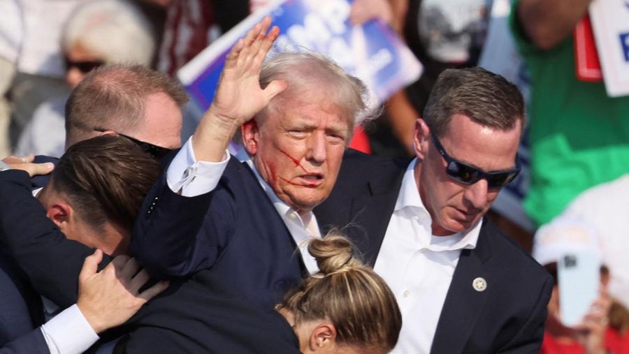 Republican presidential candidate and former U.S. President Donald Trump is assisted by U.S. Secret Service personnel after gunfire rang out during a campaign rally at the Butler Farm Show in Butler, Pennsylvania, U.S., July 13, 2024. REUTERS/Brendan McDermid
