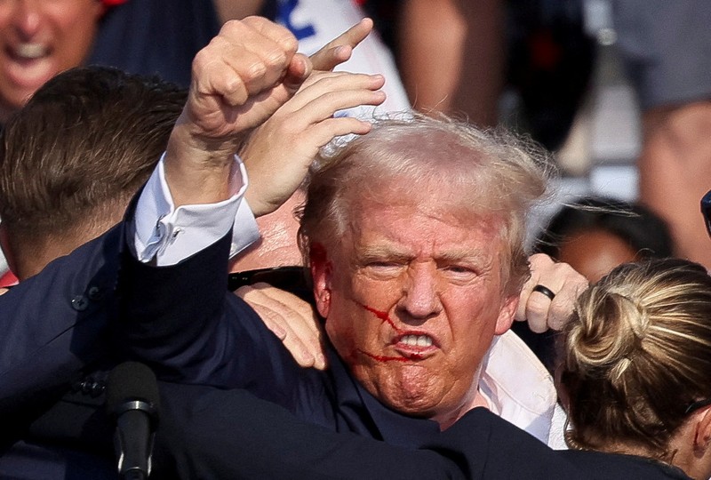 Election 2024 Trump Republican presidential candidate former President Donald Trump is helped off the stage at a campaign event in Butler, Pa., on Saturday, July 13, 2024. (AP Photo/Gene J. Puskar)