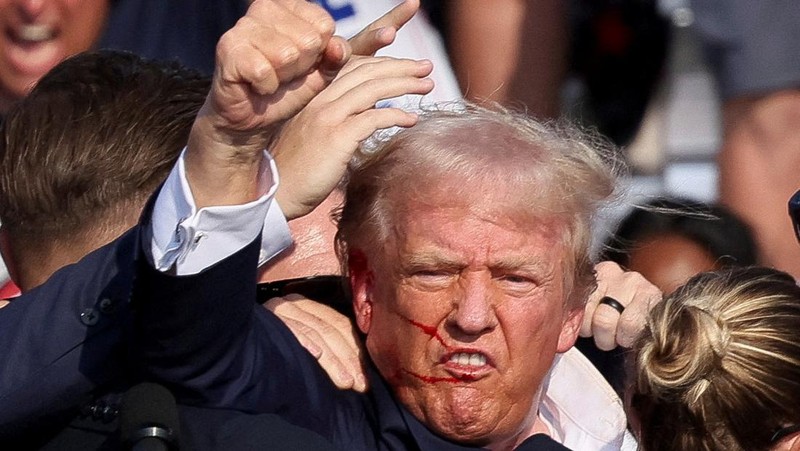 Republican presidential candidate former President Donald Trump is helped off the stage at a campaign event in Butler, Pa., on Saturday, July 13, 2024. (AP Photo/Gene J. Puskar)