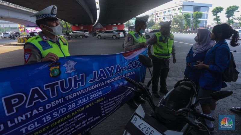 Sejumlah petugas kepolisian mengatur arus lalu lintas saat penerapan Operasi Patuh Jaya di kawasan Tomang, Jakarta Barat, Senin (15/7/2024). Korps Lalu Lintas (Korlantas) Polri menggelar Operasi Patuh Jaya 2024 yang berlangsung pada 15 - 28 Juli mendatang. (վ/Faisal Rahman)