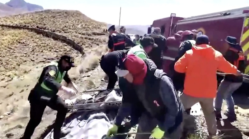 Mayat dan puing-puing tergeletak di lereng bukit di samping bus rusak yang jatuh ke jurang di lokasi terpencil di Andes, Peru, pada 16 Juli 2024. Sebuah bus jatuh ke jurang di Peru selatan, menewaskan sedikitnya 21 orang dan melukai 20 orang lainnya, kata polisi pada Selasa. (Photo by STRINGER / AFP)