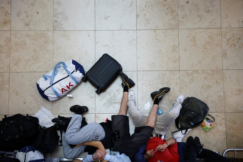 Seorang anak laki-laki tertidur di lantai saat para pelancong mengantri di Bandara Internasional Brussels di Brussels, Jumat, 19 Juli 2024. Pemadaman teknologi global membuat penerbangan terhenti, membuat bank dan sistem rumah sakit offline, dan outlet media tidak mengudara pada hari Jumat secara besar-besaran. (AP/Harry Nakos)