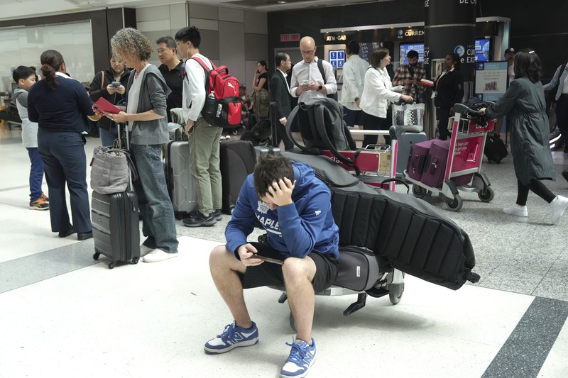 Worldwide Internet Outage New York Screens show a blue error message at a departure floor of LaGuardia Airport in New York on Friday, July 19, 2024, after a faulty CrowdStrike update caused a major internet outage for computers running Microsoft Windows. (AP Photo/Yuki Iwamura)