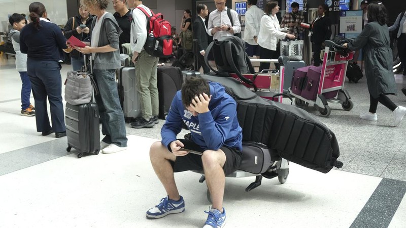 Screens show a blue error message at a departure floor of LaGuardia Airport in New York on Friday, July 19, 2024, after a faulty CrowdStrike update caused a major internet outage for computers running Microsoft Windows. (AP Photo/Yuki Iwamura)