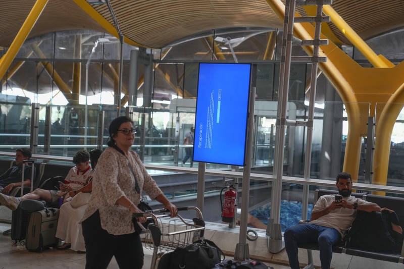 Worldwide Internet Outage New York Screens show a blue error message at a departure floor of LaGuardia Airport in New York on Friday, July 19, 2024, after a faulty CrowdStrike update caused a major internet outage for computers running Microsoft Windows. (AP Photo/Yuki Iwamura)