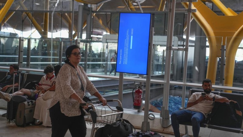 Screens show a blue error message at a departure floor of LaGuardia Airport in New York on Friday, July 19, 2024, after a faulty CrowdStrike update caused a major internet outage for computers running Microsoft Windows. (AP Photo/Yuki Iwamura)