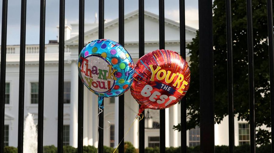Balloons that were tied to the fence are pictured as people gather outside the White House after U.S. President Joe Biden announced he is stopping his bid for reelection, in Washington, D.C., U.S., July 21, 2024. REUTERS/Kevin Mohatt     TPX IMAGES OF THE DAY
