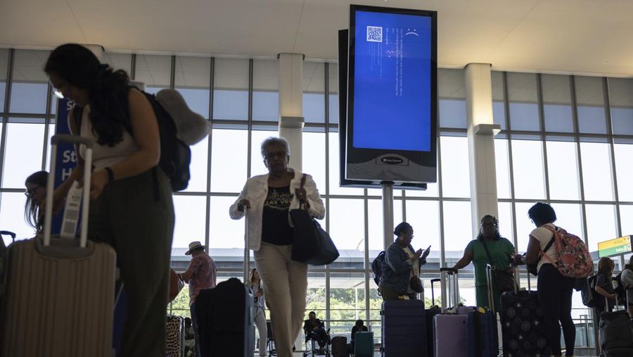Screens show a blue error message at a departure floor of LaGuardia Airport in New York on Friday, July 19, 2024, after a faulty CrowdStrike update caused a major internet outage for computers running Microsoft Windows. (AP Photo/Yuki Iwamura)