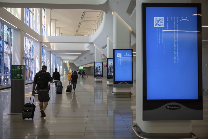 Worldwide Internet Outage New York Screens show a blue error message at a departure floor of LaGuardia Airport in New York on Friday, July 19, 2024, after a faulty CrowdStrike update caused a major internet outage for computers running Microsoft Windows. (AP Photo/Yuki Iwamura)