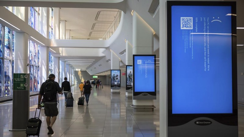 Screens show a blue error message at a departure floor of LaGuardia Airport in New York on Friday, July 19, 2024, after a faulty CrowdStrike update caused a major internet outage for computers running Microsoft Windows. (AP Photo/Yuki Iwamura)