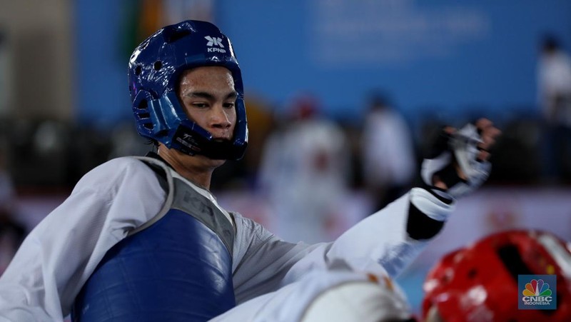 Atlet taekwondo berlaga dalam Ajang turnamen rangkaian Road to PON XXI, KONI-Bayan Championship 2024 di Universitas Mulawarman (Unmul) Samarinda, Kalimantan Timur, Selasa (23/7/2024). (CNBC Indonesia/Tri Susilo)