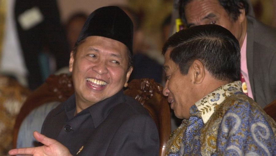 Indonesia's Vice President Hamzah Haz, left, chats with transportation minister Agum Gumelar during a seminar in Jakarta, Indonesia, Wednesday, Dec. 18, 2002. Haz, a hard-line Islamic politician who has previously defended radicals and denied that Indonesia had a terrorism problem, on Tuesday downplayed his past differences with President Megawati Sukarnoputri saying that Indonesia's government is now united in fighting terrorism. (AP Photo/Muchtar Zakaria)
