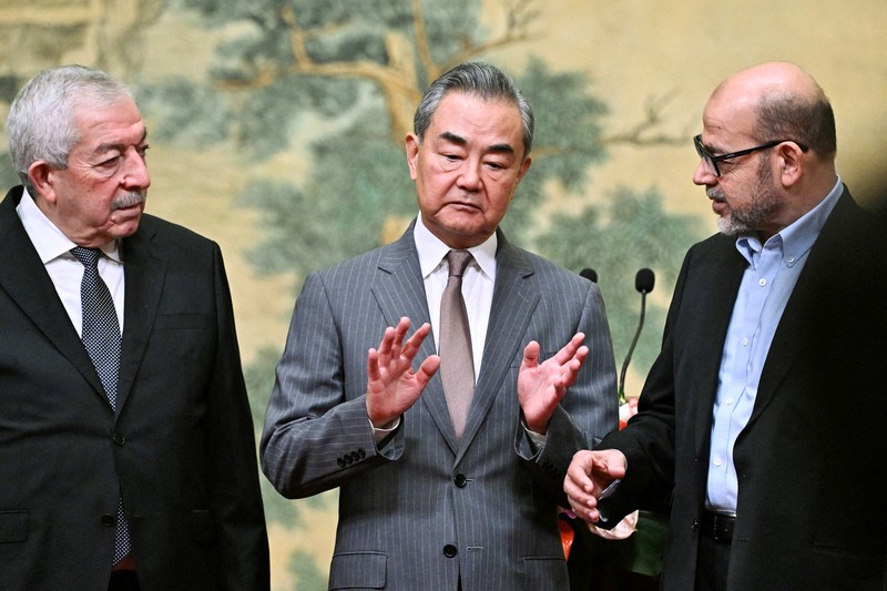 ISRAEL-PALESTINIANS/CHINA China's Foreign Minister Wang Yi looks on during the signing of the