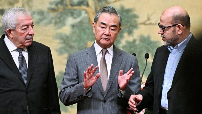 China's Foreign Minister Wang Yi looks on during the signing of the 