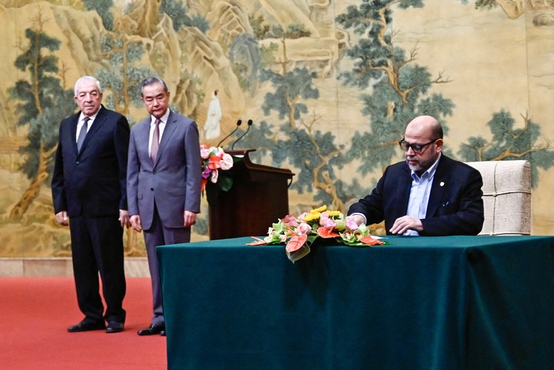 ISRAEL-PALESTINIANS/CHINA China's Foreign Minister Wang Yi looks on during the signing of the