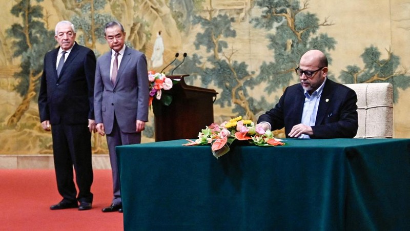 China's Foreign Minister Wang Yi looks on during the signing of the 