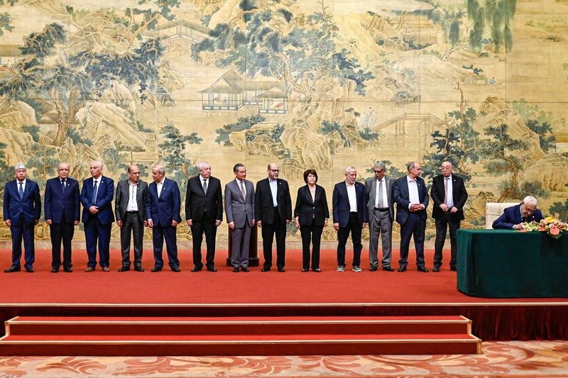China's Foreign Minister Wang Yi looks on during the signing of the 