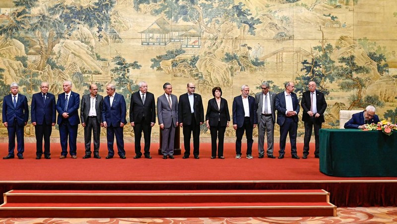 China's Foreign Minister Wang Yi looks on during the signing of the 