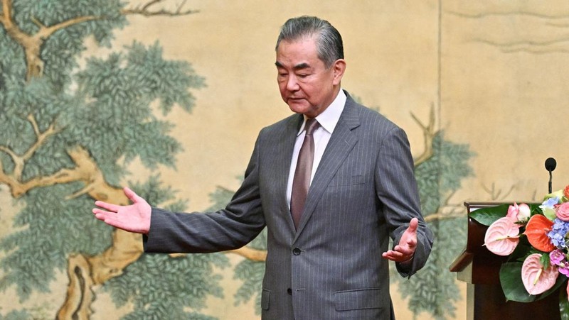 China's Foreign Minister Wang Yi looks on during the signing of the 