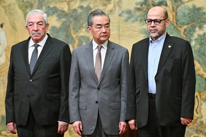 ISRAEL-PALESTINIANS/CHINA China's Foreign Minister Wang Yi looks on during the signing of the