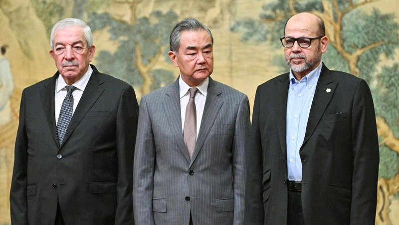 China's Foreign Minister Wang Yi looks on during the signing of the 