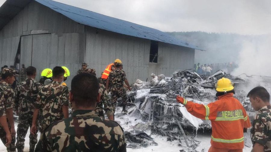 Asap mengepul dari Bandara Internasional Tribhuvan di Kathmandu, Nepal, Rabu, 24 Juli 2024. Televisi pemerintah di Nepal melaporkan sebuah pesawat tergelincir dari landasan dan jatuh saat mencoba lepas landas dari bandara Kathmandu. (AP Photo/Agniia Galdanova)