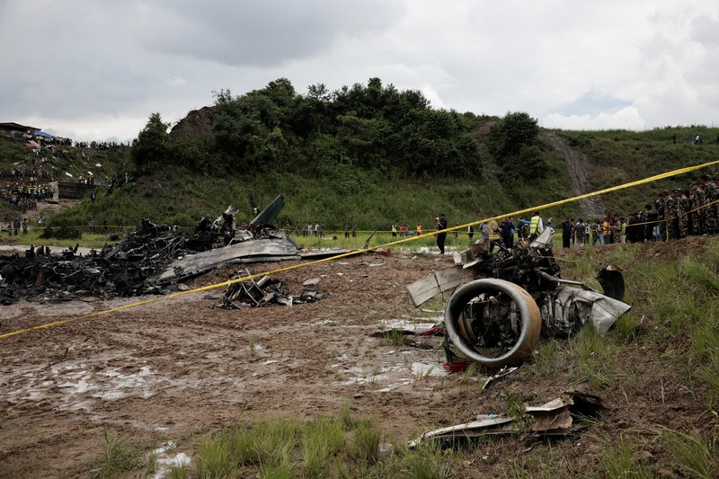 Pemandangan menunjukkan puing-puing pesawat Saurya Airlines yang terbakar setelah tergelincir dari landasan pacu saat lepas landas di Bandara Internasional Tribhuvan, di Kathmandu, Nepal, 24 Juli 2024. Pemandangan menunjukkan puing-puing pesawat Saurya Airlines yang terbakar setelah tergelincir dari landasan pacu saat lepas landas di Bandara Internasional Tribhuvan, di Kathmandu, Nepal, 24 Juli 2024. (REUTERS/Navesh Chitrakar)