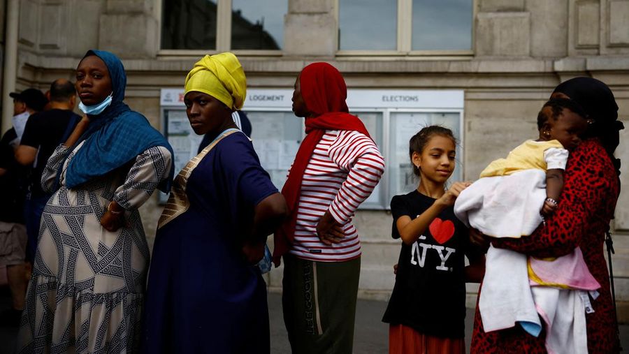 Homeless families, who were evacuated from street camps, camp out in front of the city hall of Paris' 18th district calling attention to their lack of housing ahead of the Paris 2024 Olympic Games, in Paris, France, July 25, 2024.  REUTERS/Sarah Meyssonnier