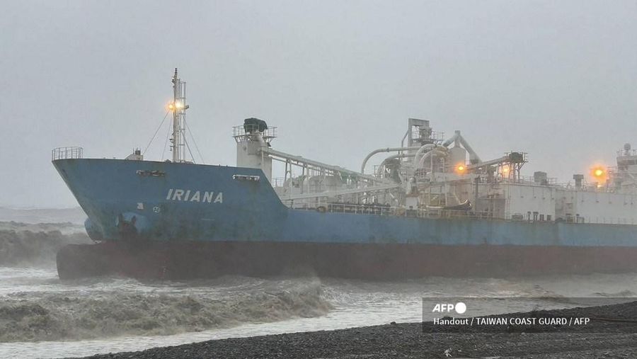 This handout picture taken and released on July 25, 2024 by the Taiwan Coast Guard shows the Indonesia-flagged cargo ship Iriana stranded near the coast in Pingtung County during Typhoon Gaemi. The typhoon -- the strongest to hit Taiwan in eight years -- had already forced authorities on the island to close schools and offices, suspend the stock market and evacuate thousands of people. (Photo by Handout / TAIWAN COAST GUARD / AFP) / RESTRICTED TO EDITORIAL USE - MANDATORY CREDIT