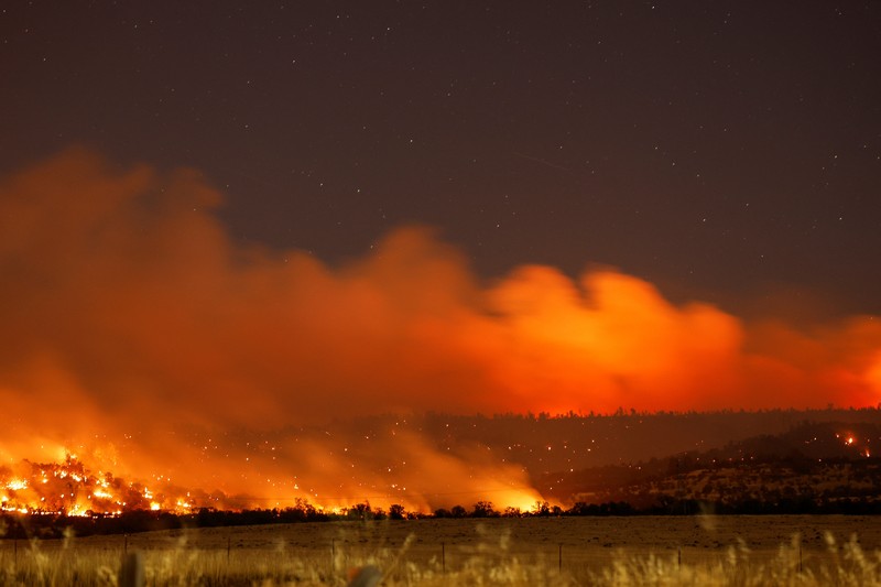 A firefighter works as Park Fire burns near Chico, California, U.S. July 24, 2024.  REUTERS/Fred Greaves