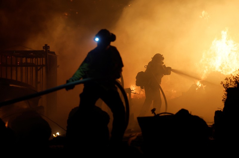 A firefighter works as Park Fire burns near Chico, California, U.S. July 24, 2024.  REUTERS/Fred Greaves