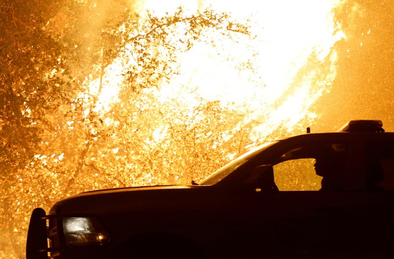 A firefighter works as Park Fire burns near Chico, California, U.S. July 24, 2024.  REUTERS/Fred Greaves