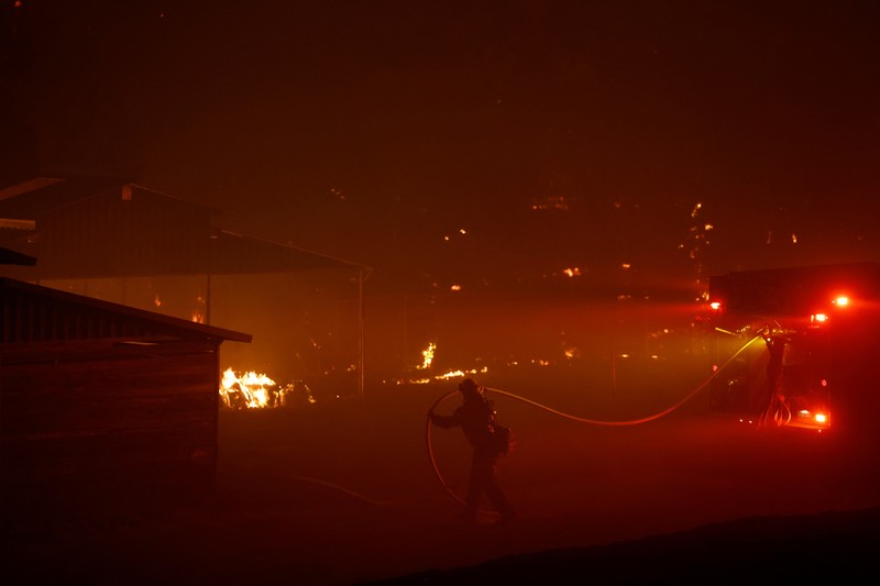 A firefighter works as Park Fire burns near Chico, California, U.S. July 24, 2024.  REUTERS/Fred Greaves