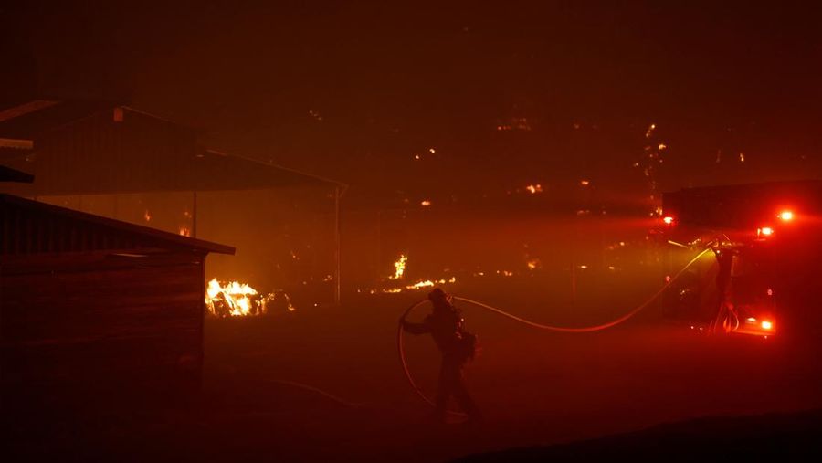 A firefighter works as Park Fire burns near Chico, California, U.S. July 24, 2024.  REUTERS/Fred Greaves