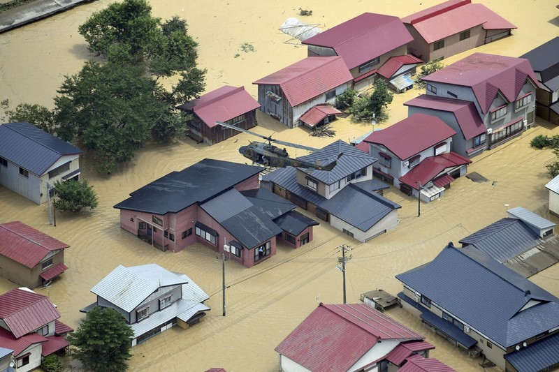 ASIA-WEATHER/JAPAN An aerial view shows a submerged residential area along Mogami river due to heavy rain in Tozawa Town, Yamagata Prefecture, northern Japan July 26, 2024, in this photo taken by Kyodo. Mandatory credit Kyodo/via REUTERS ATTENTION EDITORS - THIS IMAGE HAS BEEN SUPPLIED BY A THIRD PARTY. MANDATORY CREDIT. JAPAN OUT. NO COMMERCIAL OR EDITORIAL SALES IN JAPAN.