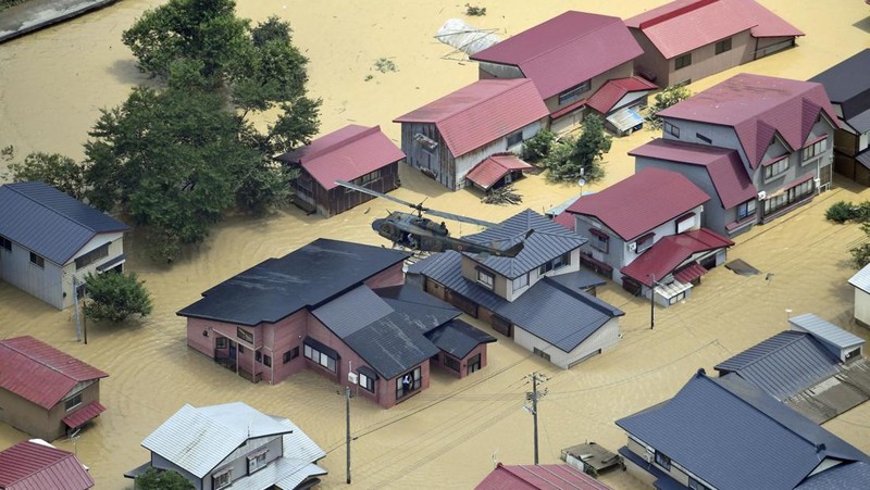 An aerial view shows a submerged residential area along Mogami river due to heavy rain in Tozawa Town, Yamagata Prefecture, northern Japan July 26, 2024, in this photo taken by Kyodo. Mandatory credit Kyodo/via REUTERS   ATTENTION EDITORS - THIS IMAGE HAS BEEN SUPPLIED BY A THIRD PARTY. MANDATORY CREDIT. JAPAN OUT. NO COMMERCIAL OR EDITORIAL SALES IN JAPAN.