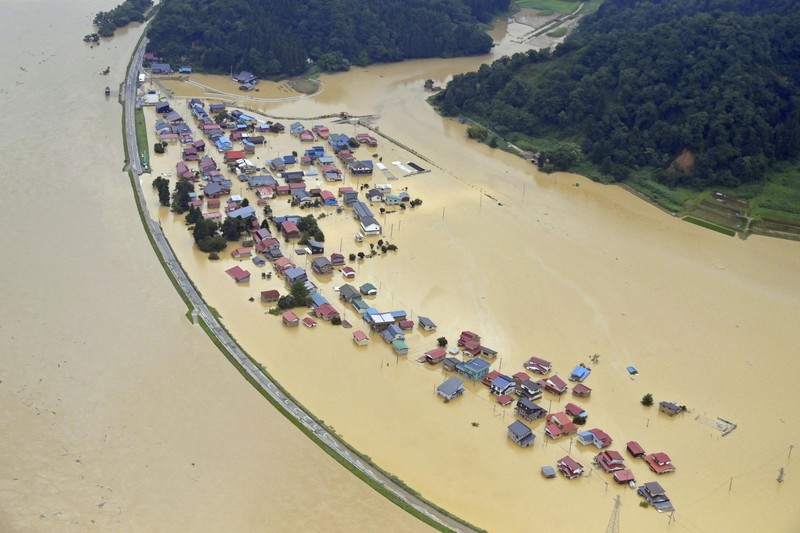 ASIA-WEATHER/JAPAN An aerial view shows a submerged residential area along Mogami river due to heavy rain in Tozawa Town, Yamagata Prefecture, northern Japan July 26, 2024, in this photo taken by Kyodo. Mandatory credit Kyodo/via REUTERS ATTENTION EDITORS - THIS IMAGE HAS BEEN SUPPLIED BY A THIRD PARTY. MANDATORY CREDIT. JAPAN OUT. NO COMMERCIAL OR EDITORIAL SALES IN JAPAN.