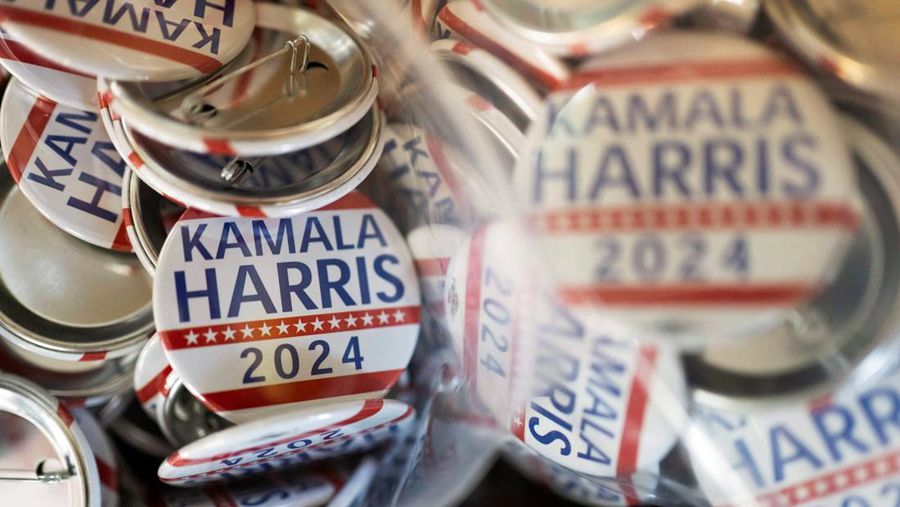 Juru cetak sablon Chris Fleury meletakkan kaus yang baru dicetak untuk mendukung kampanye kepresidenan Wakil Presiden AS Kamala Harris ke mesin pengering konveyor di Pabrik Gloo di Tucson, Arizona, AS, 25 Juli 2024. (REUTERS/Rebecca Noble)