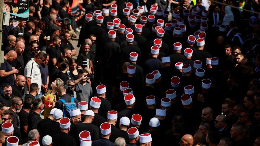 Warga berkumpul mengantarkan jenazah saat pemakaman  anak-anak yang tewas pada sebuah lapangan sepak bola akibat serangan roket Hizbullah di Desa Druze, Dataran Tinggi Golan yang dikuasai Israel, Minggu (28/7/2024). (REUTERS/Ammar Awad)